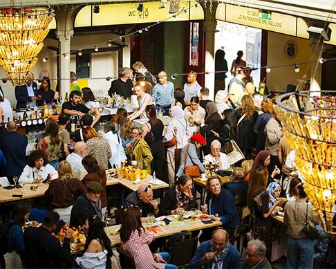 Visitors and food stalls inside Marché Saint-Géry